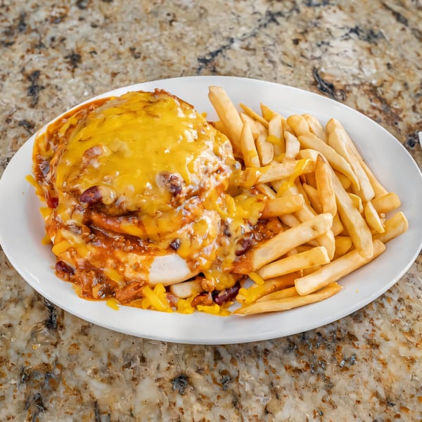 Chili cheese omelette with a side of french fries on a white plate at Omelette Factory Santee.